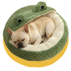 Dog lying in a green frog-shaped pet bed